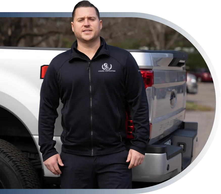 Nick Capps, founder of Citadel Contracting, standing beside his truck
