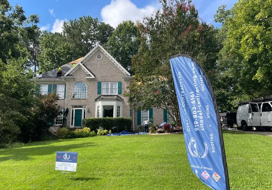 Citadel Contracting flag and yard sign in front of a two-story home